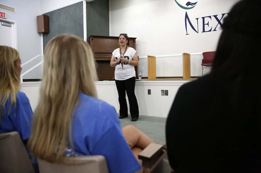 Wendy Birdsall, 41, talks to Celanese employee volunteers at Nexus Recovery Center in Dallas...