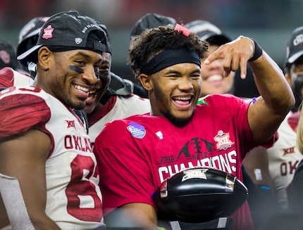 Oklahoma Sooners quarterback Kyler Murray (1) holds up upside down horns after receiving the...