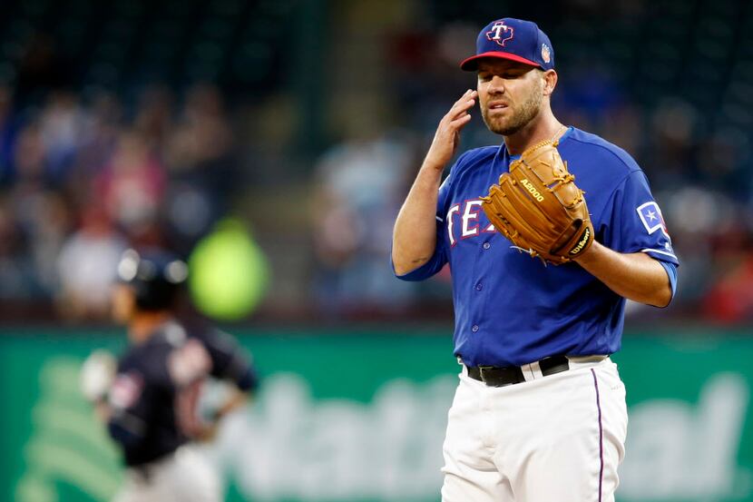 Texas Rangers starting pitcher Colby Lewis (48) reacts as Cleveland Indians catcher Yan...