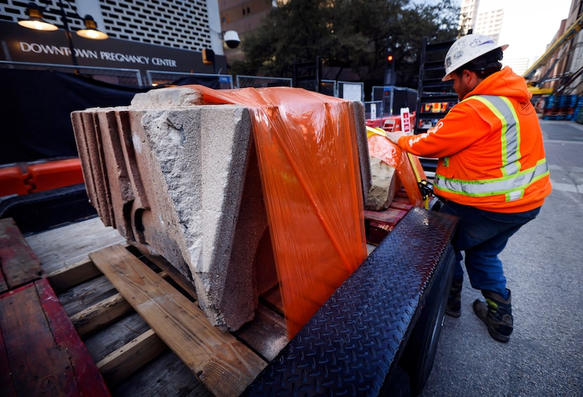 Crewman Joey Trachtenberg secures some of the cornices from the crumbling north wall of the...