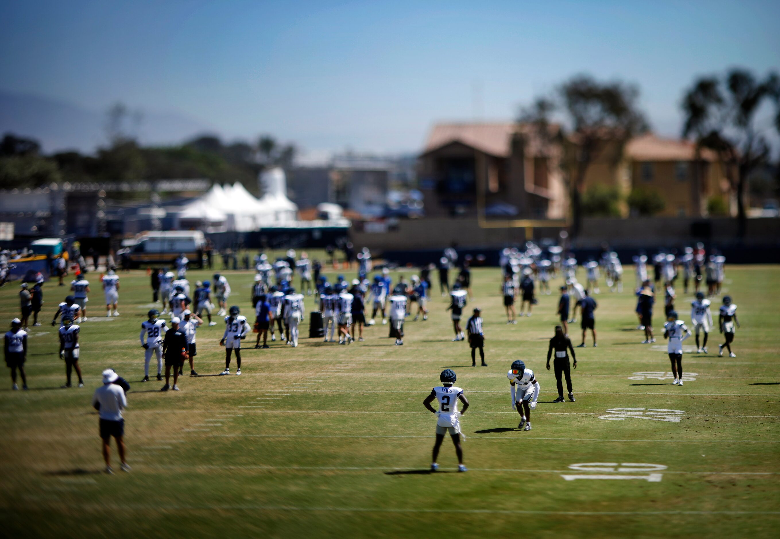 The Dallas Cowboys football team stretches on the field before a training camp scrimmage...