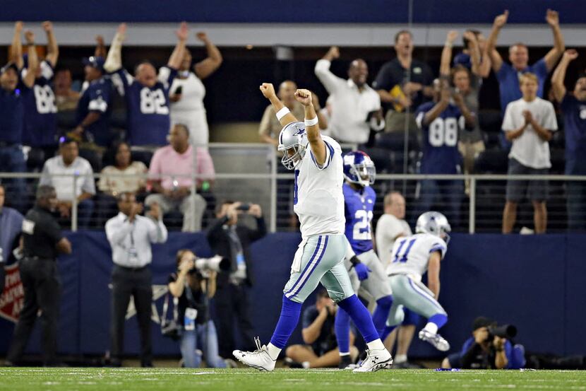 FILE - Dallas Cowboys quarterback Tony Romo celebrates his game-winning touchdown to tight...