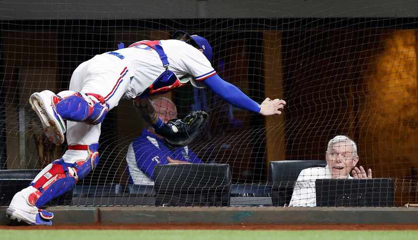 Texas Rangers co-chairman Ray C. Davis reacted as catcher Jonah Heim went into the netting...