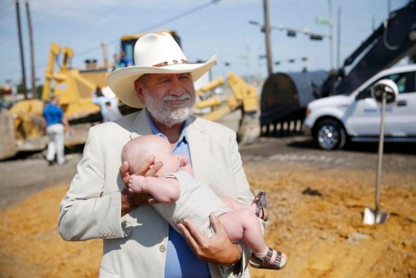 
J.R. Wade held 3-month-old Lenox Burge, the youngest member of the Wade family, after...