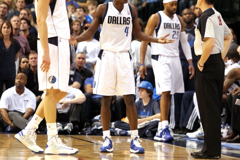 Dallas' Darren Collison (4) questions the critical foul call on Eric Gordon's shot that gave...