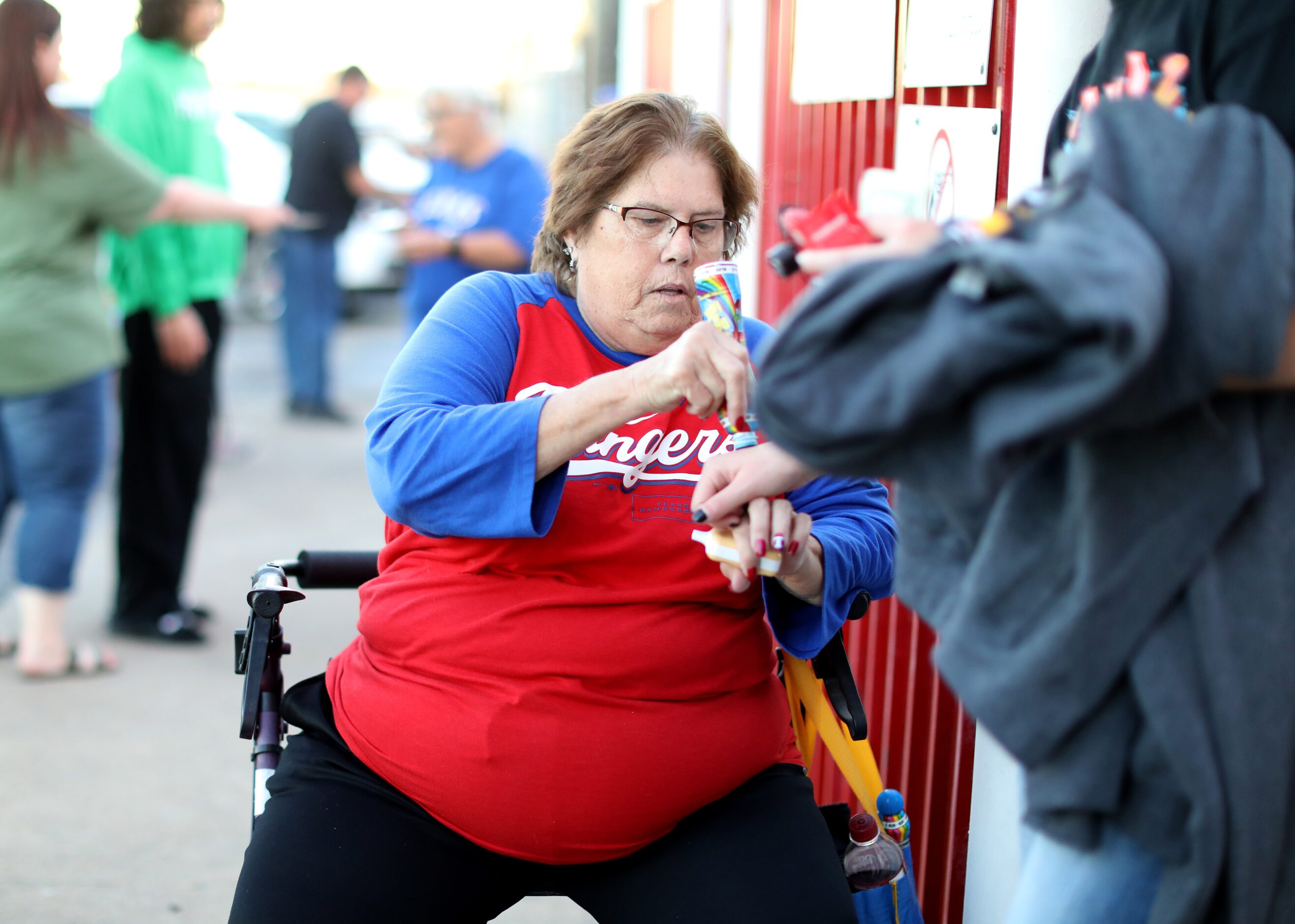 Charlott Hoover, who says she's worked at the venue from the beginning, stamps hands for...