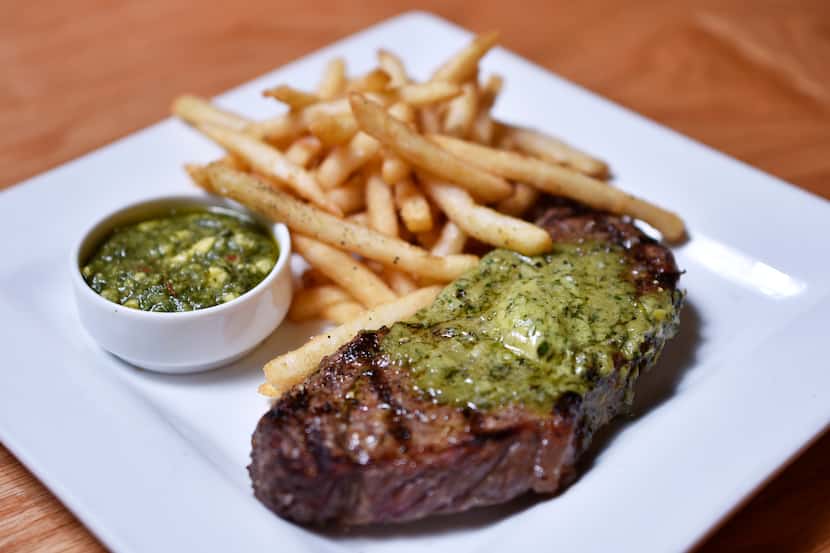 The $22 steak frites dish is a New York strip topped with avocado-herb butter and fries.