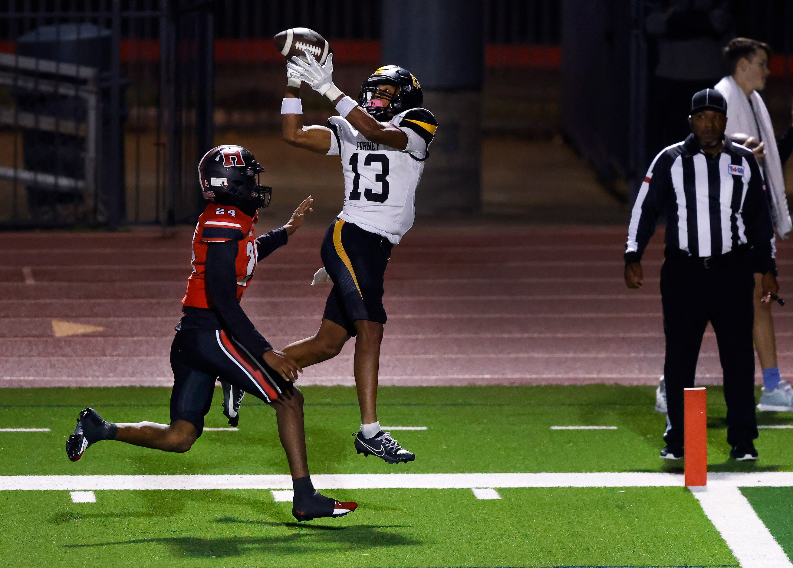 Forney wide receiver Preston Jackson (13) turns and catches a touchdown pass ahead of...