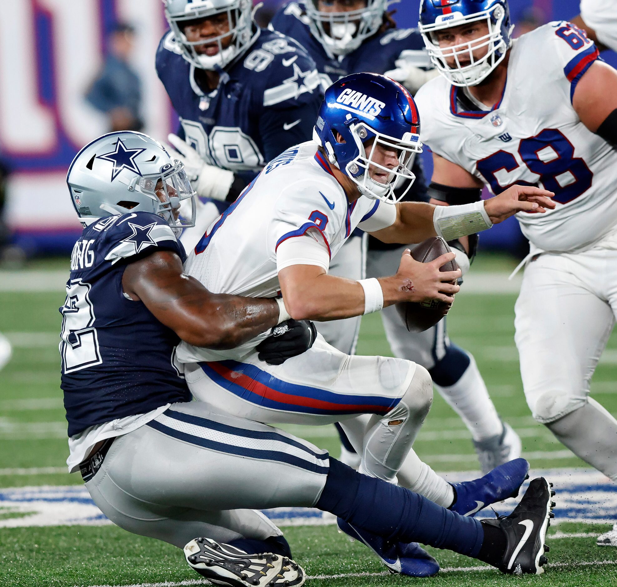 Dallas Cowboys defensive end Dorance Armstrong (92) sacks New York Giants quarterback Daniel...