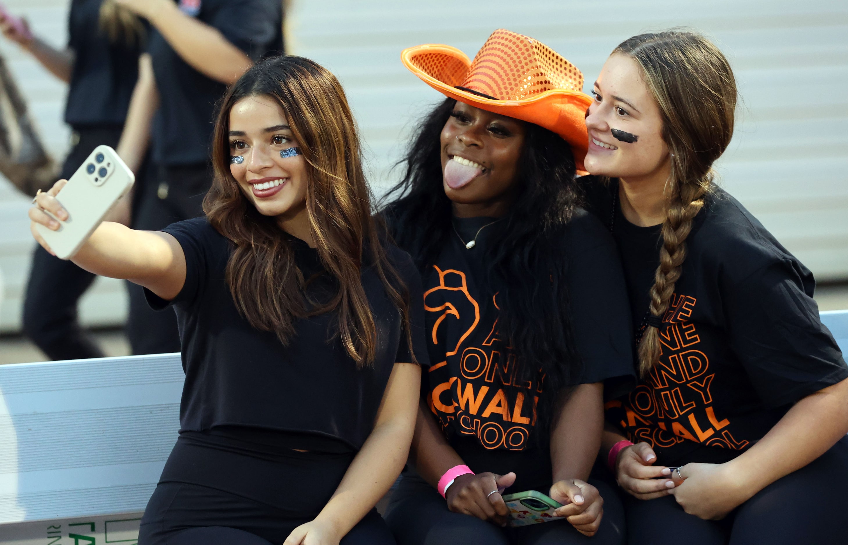 Rockwall High fans pose for a selfie on the sideline before  the first half of a high school...