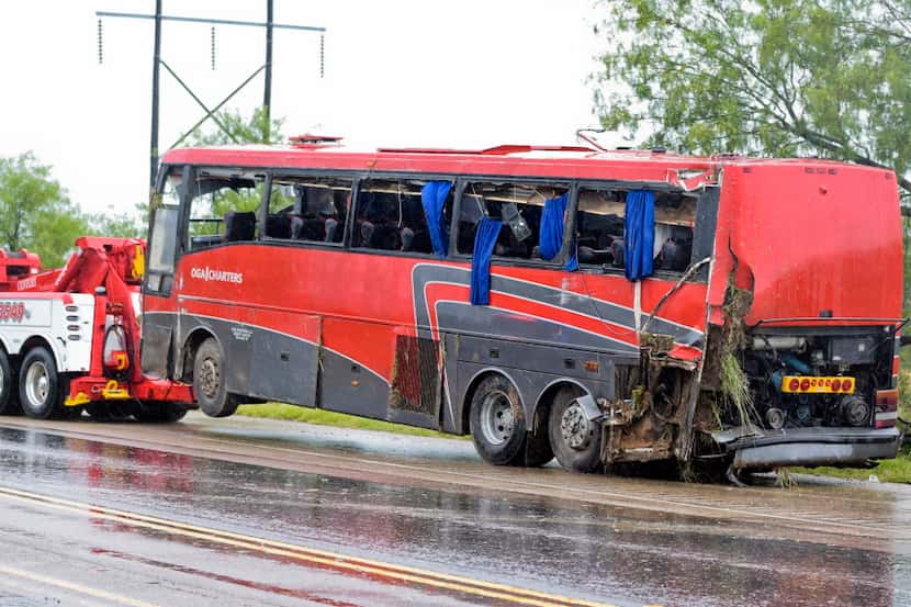  A damaged OGA Charters bus is hauled away after a fatal rollover Saturday on U.S. 83 North...