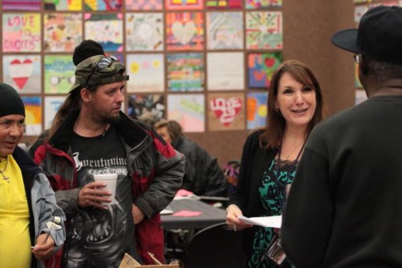 
Dallas Public Library director Jo Giudice (second from right) spends time with homeless...