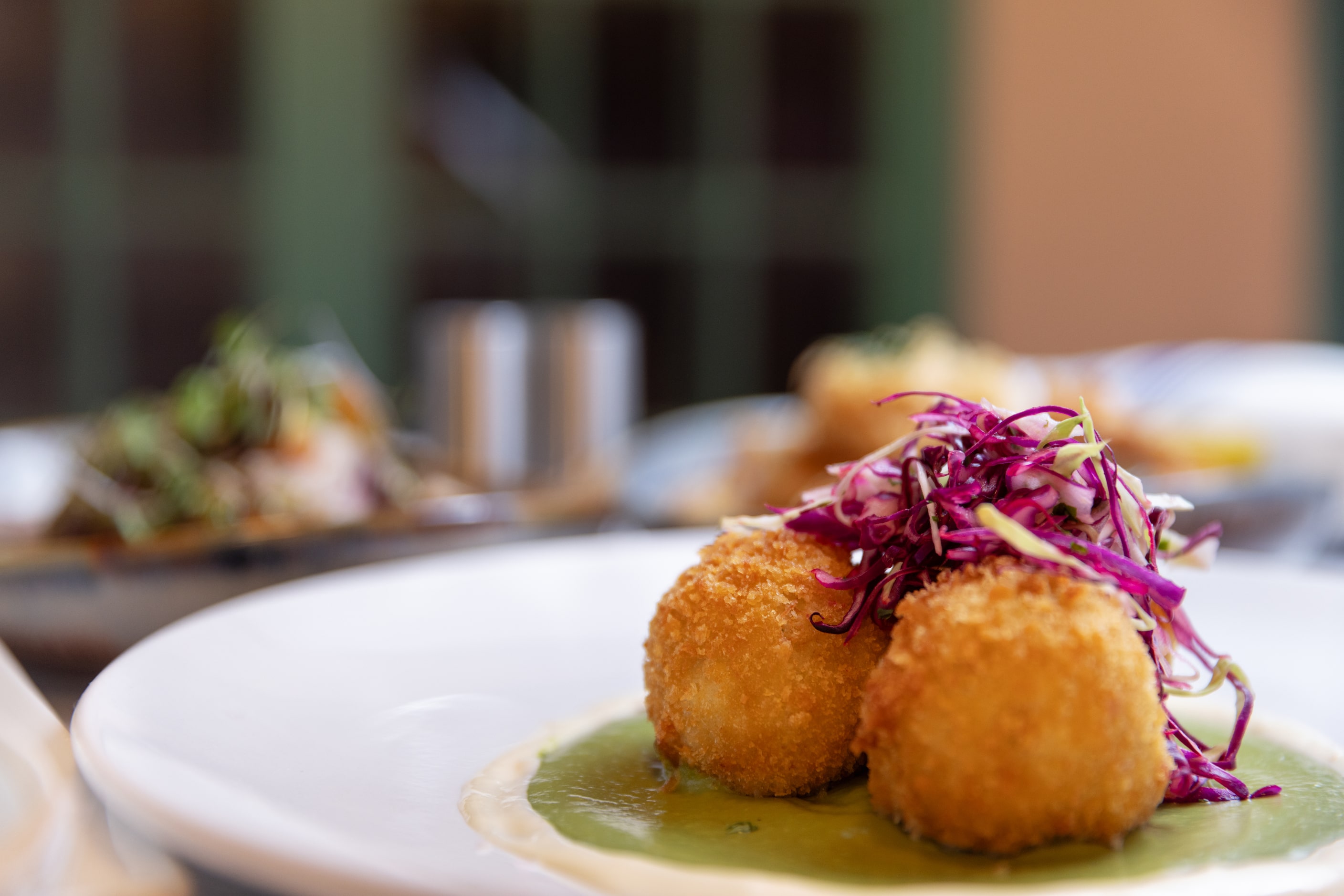 Crab croquettes with avocado puree, habanero aioli and pesca slaw is offered at Pesca in...