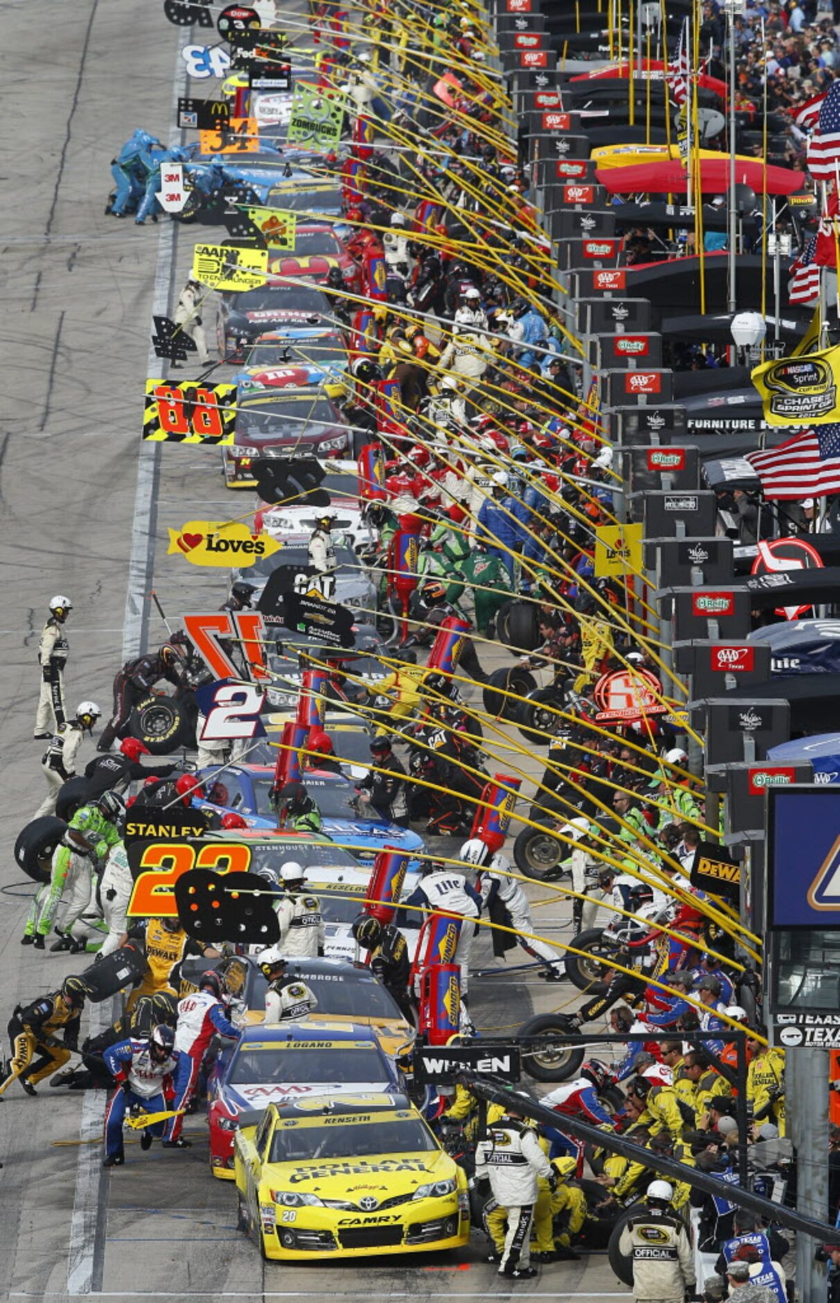 Sprint Cup Series drivers pull into the pits for four-tire changes in the first part of the...