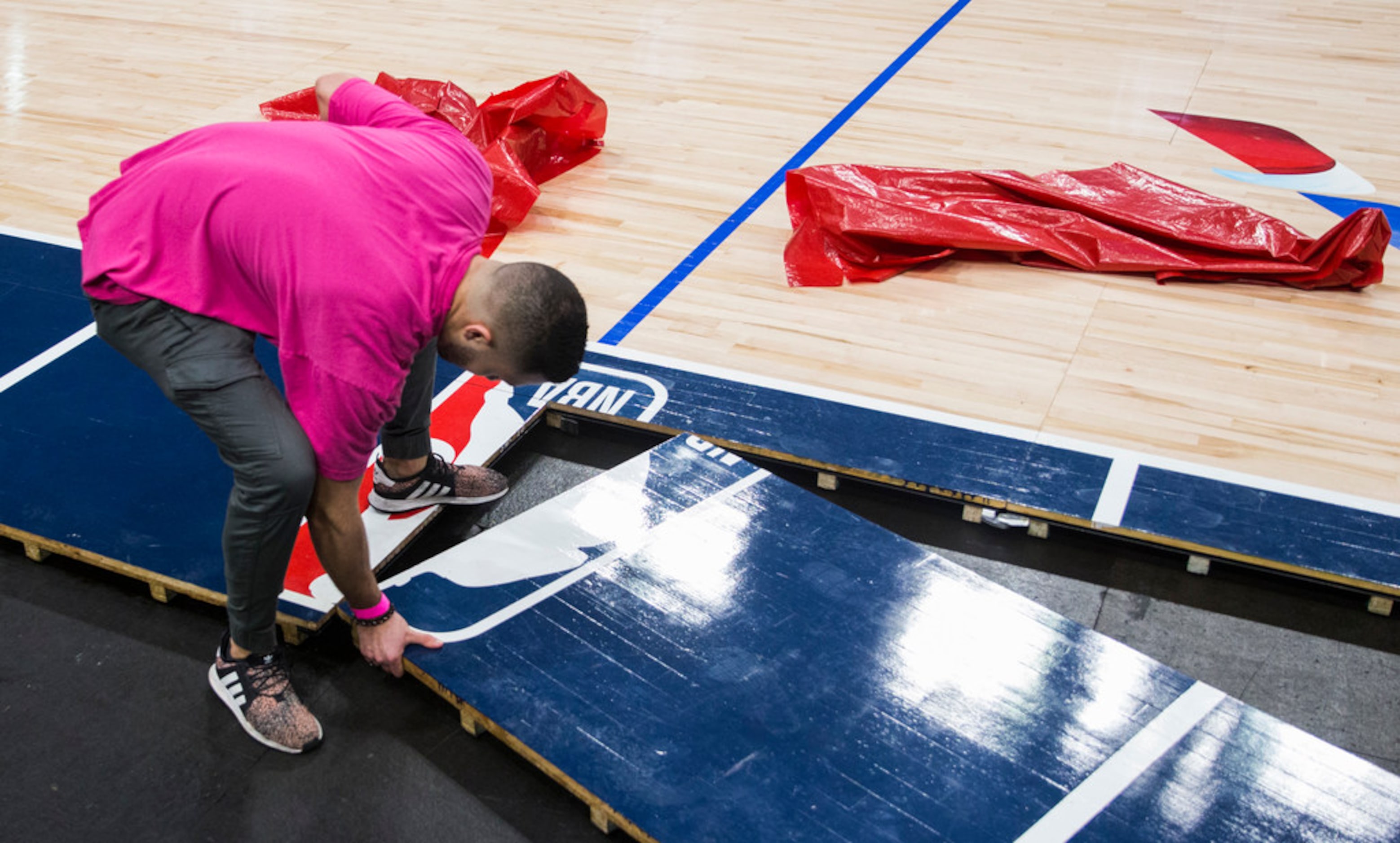 Crews break down the court after the Dallas Mavericks beat the Denver Nuggets 113-97 on...