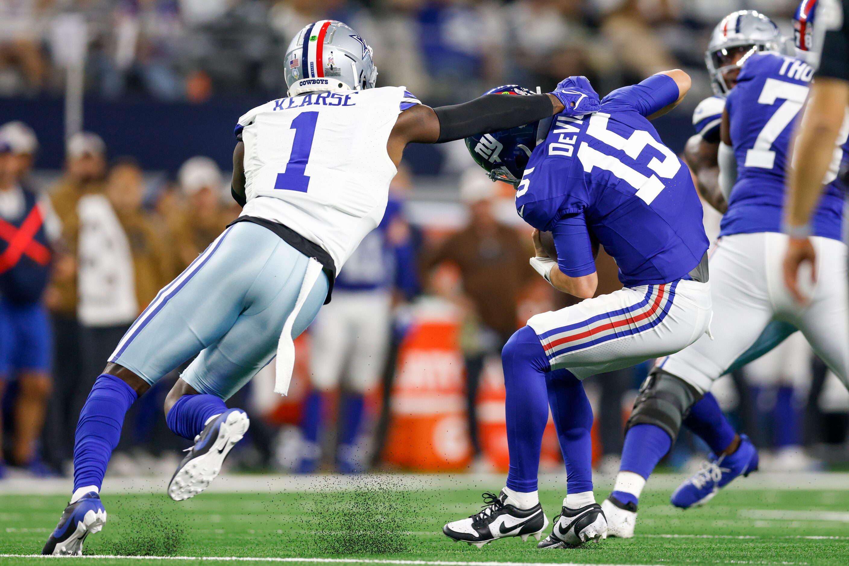 New York Giants quarterback Tommy DeVito (15) slips a sack from Dallas Cowboys safety Jayron...