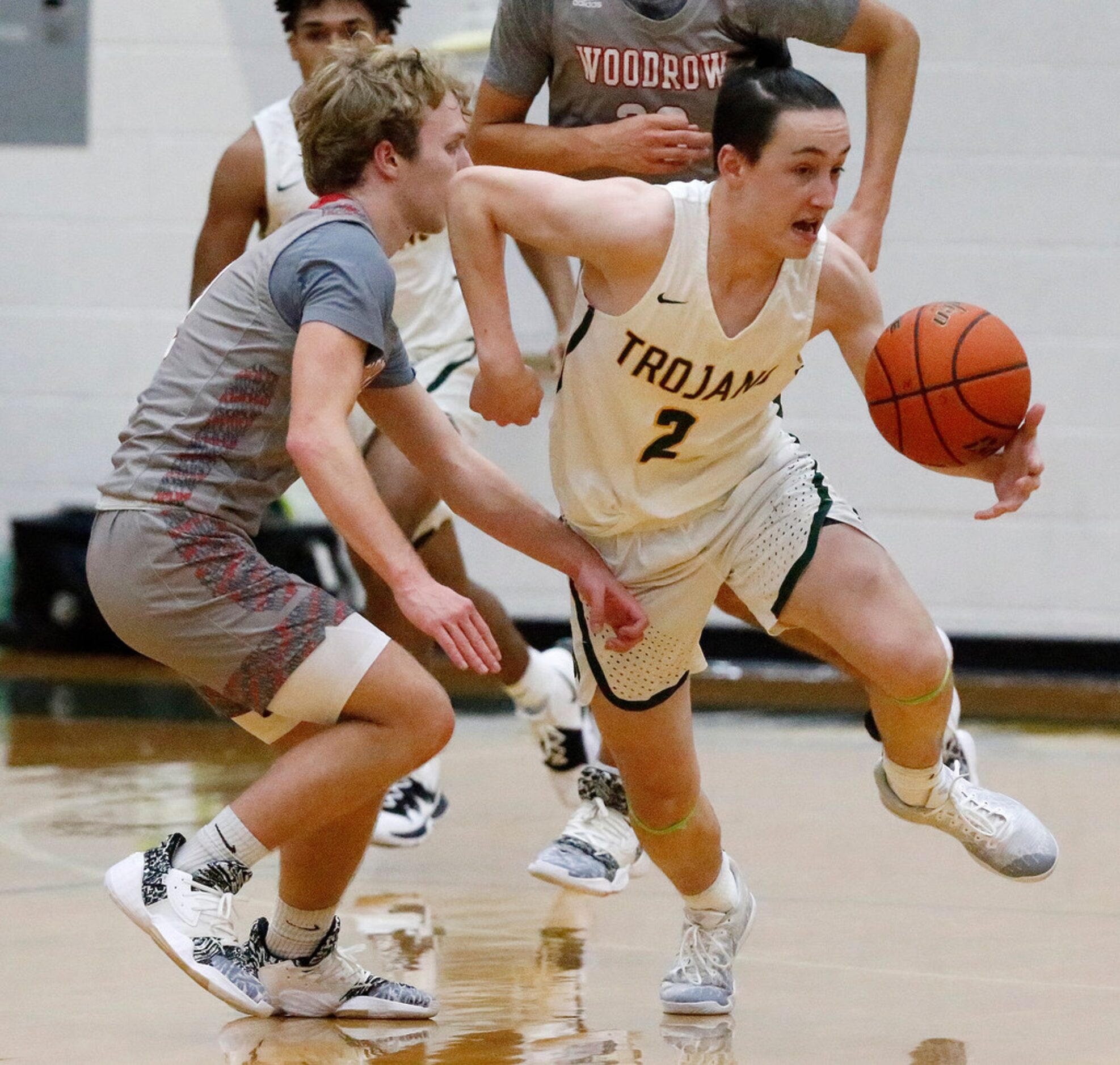 Newman Smith High School guard Thibaut Tagnon (2) tries to get around Woodrow Wilson High...