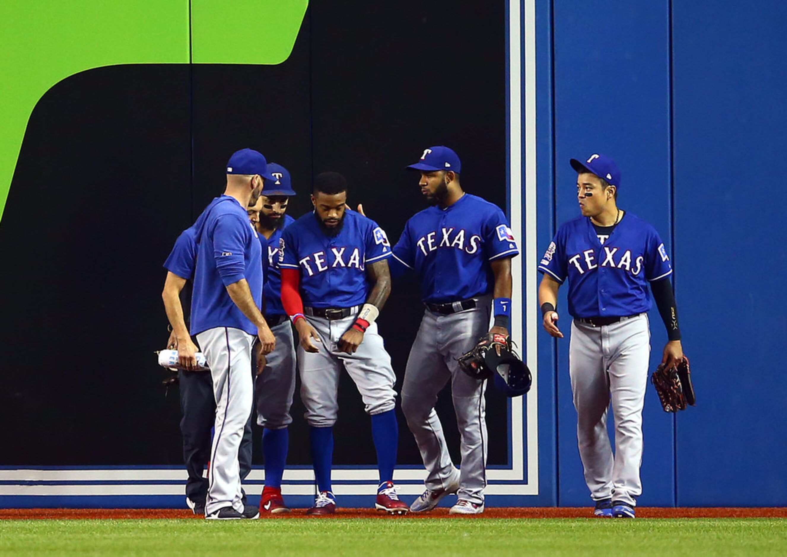 TORONTO, ON - AUGUST 13:  Delino DeShields #3 of the Texas Rangers is tended too by...