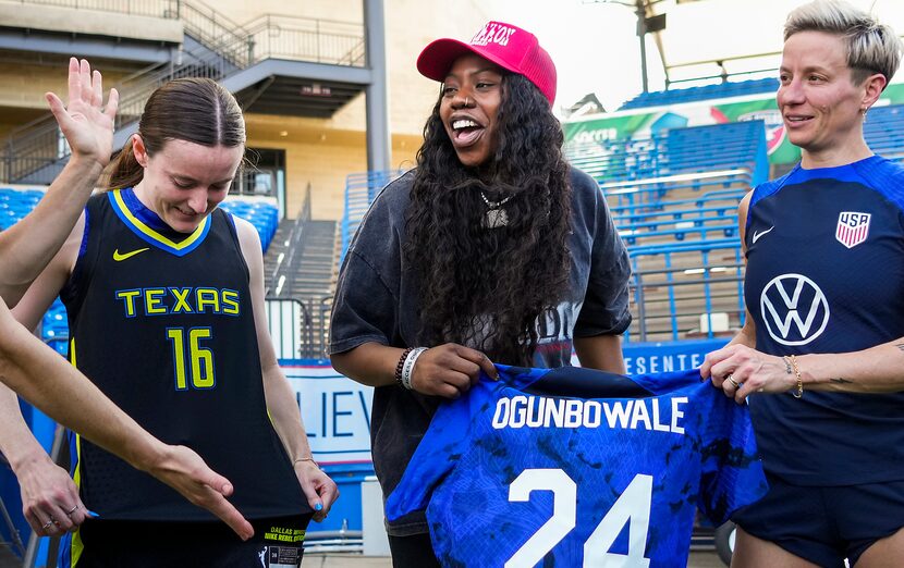 USWNT midfielder Rose Lavelle (left) swapped jerseys with Dallas Wings guard Arike...