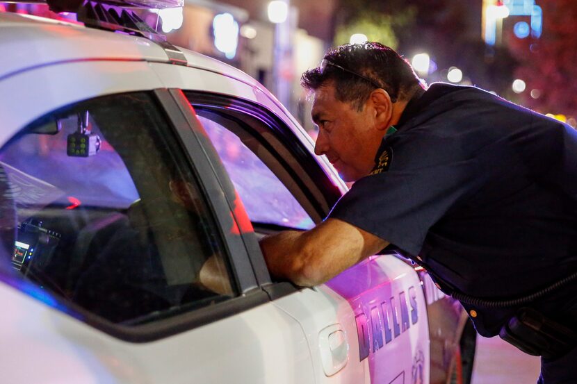 Herrera visits with another officer while on patrol in Dallas' Deep Ellum entertainment...