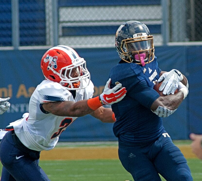 Florida International's Richard Leonard, right, returns a punt during the second quarter of...