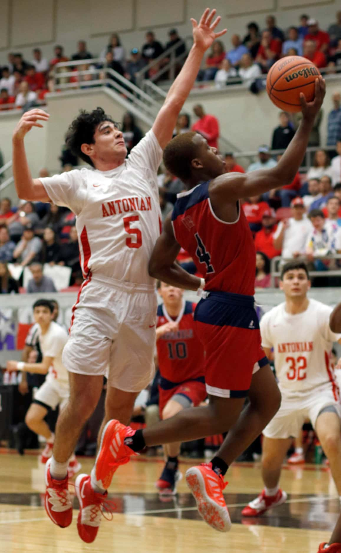 John Paul ll-Plano guard Jajuan Tot (4) drives to the basket past the defense of Antonian...