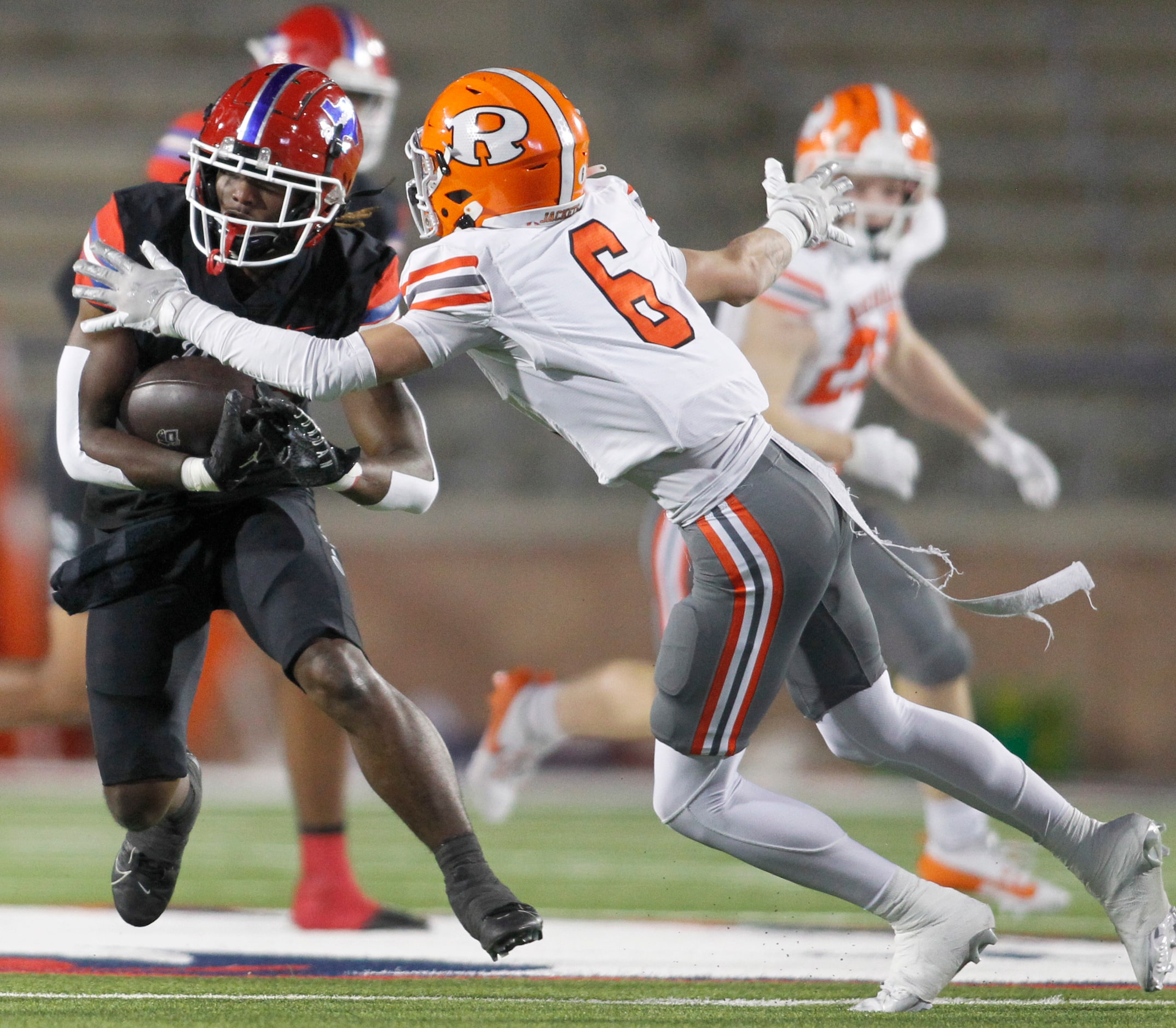 Duncanville running back Devine Green (28), left, rushes for a first down before he is...