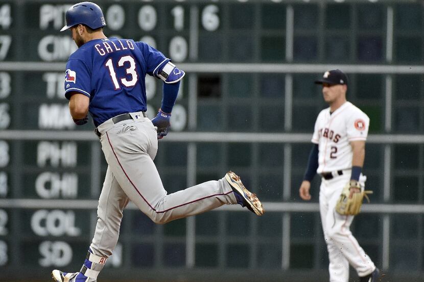 HOUSTON, TX - MAY 2: Joey Gallo #13 of the Texas Rangers rounds the bases after hitting a...