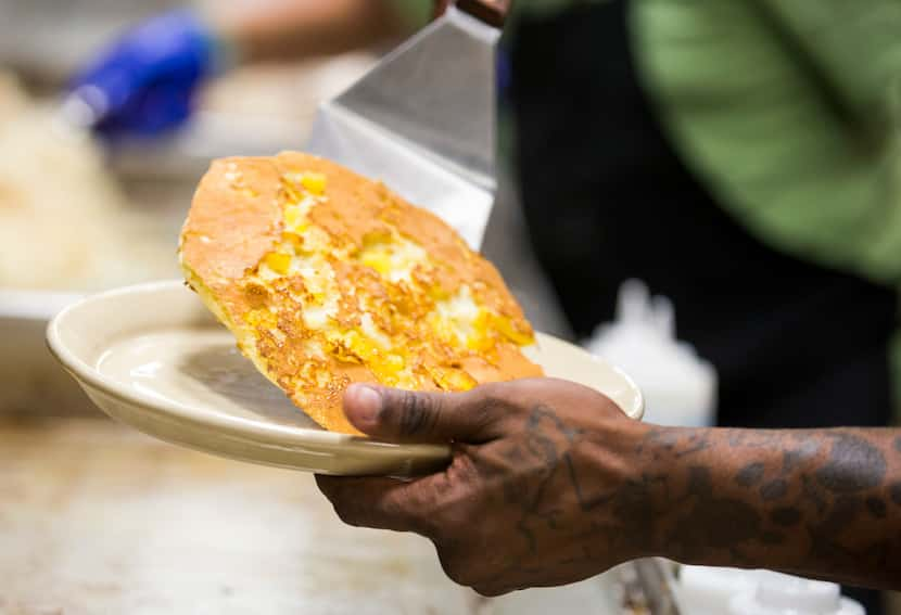 A pineapple upside-down pancake comes off the griddle in the kitchen at Snooze, an A.M....