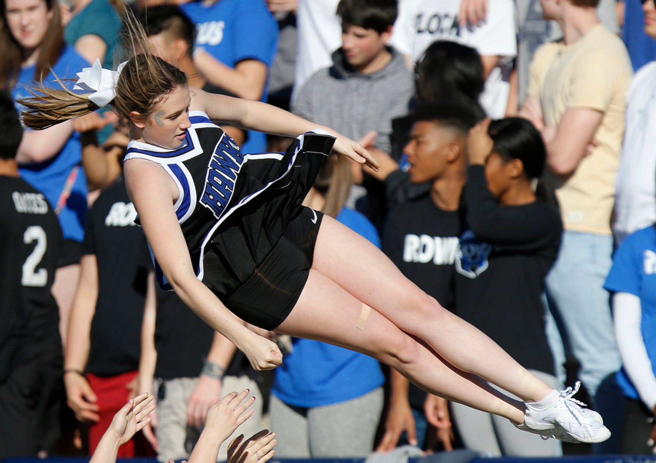 Hebron High School cheerleader Brookelyn Lundy  is tossed into the air during a cheer in the...