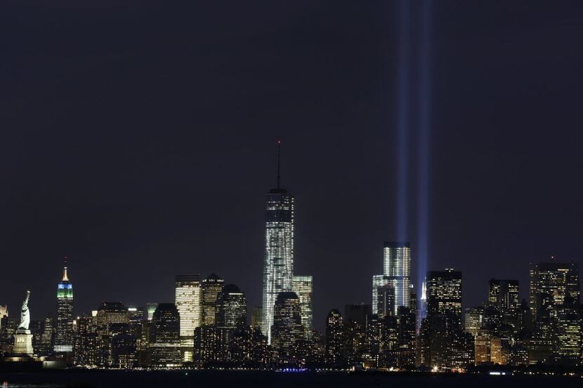 The Tribute in Light rises above the lower Manhattan skyline and One World Trade Center,...