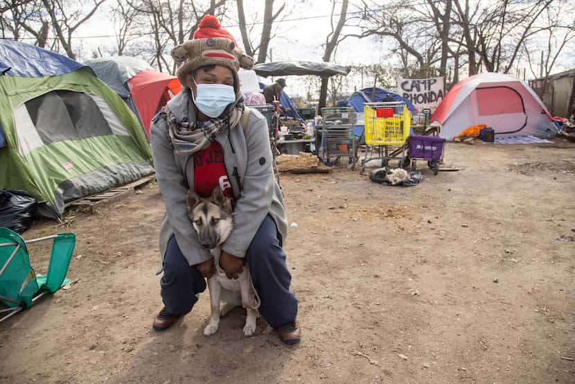 Angel Sharpe poses with her dog Bella at Camp Rhonda, a homeless encampment located on a lot...