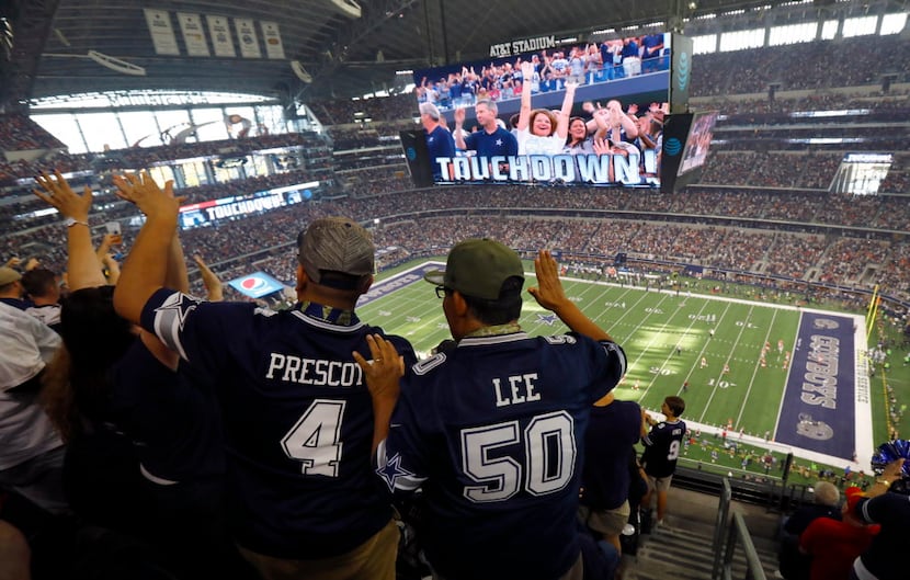Dallas Cowboys fans celebrate wide receiver Cole Beasley's (11) first quarter touchdown...
