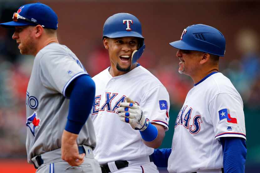 Texas Rangers center fielder Carlos Gomez (14) laughs at the dugout after a repeated rooster...
