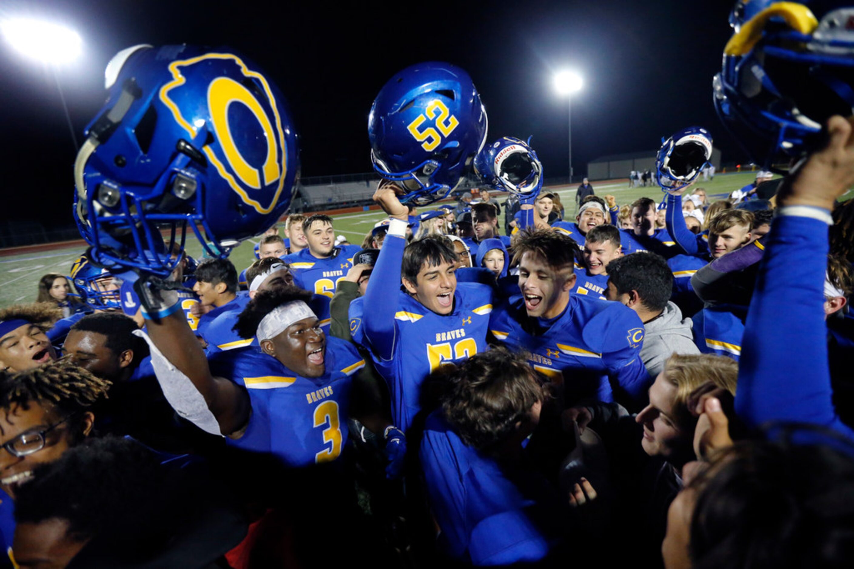 The Community High football team and students celebrate their win over Dallas Roosevelt at...