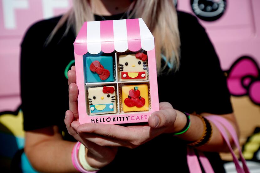 Brittany Broussard holds a package of cakes in front of the Hello Kitty food truck at The...