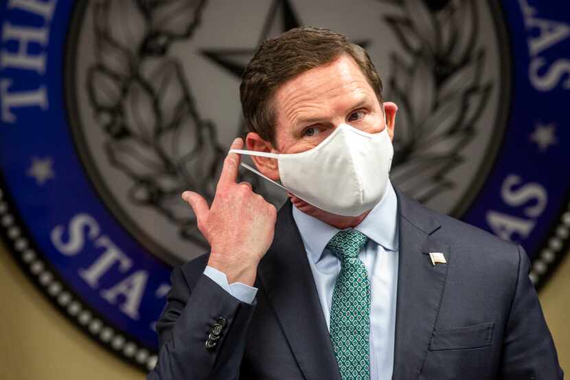 Dallas County Judge Clay Jenkins removes his mask before a press conference at the Dallas...