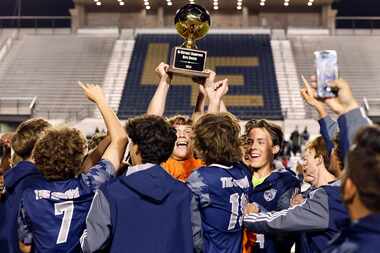 Prosper Walnut Grove players celebrate with the Bi-district trophy after winning  a UIL...