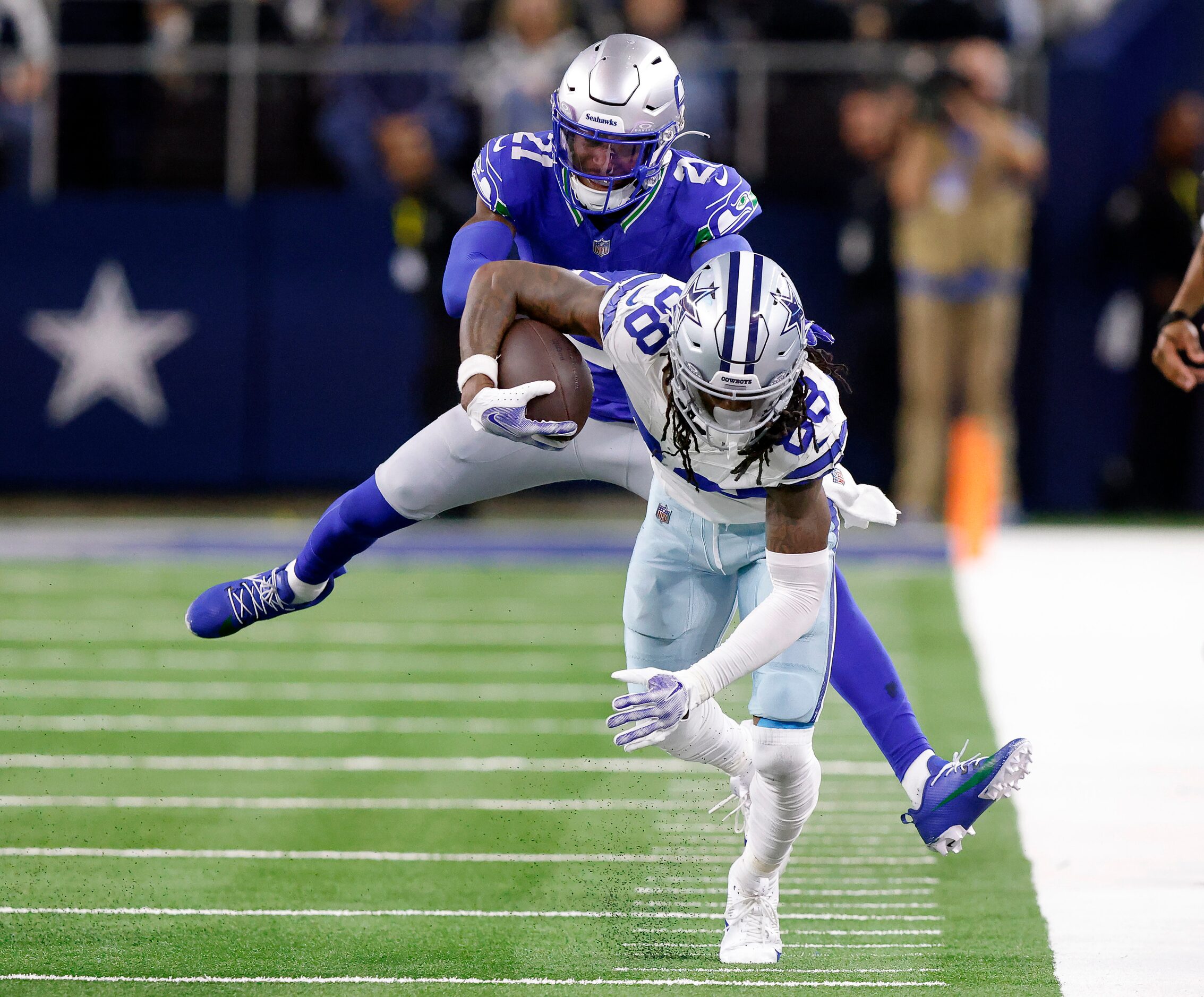 Seattle Seahawks cornerback Devon Witherspoon (21) rides Dallas Cowboys wide receiver CeeDee...