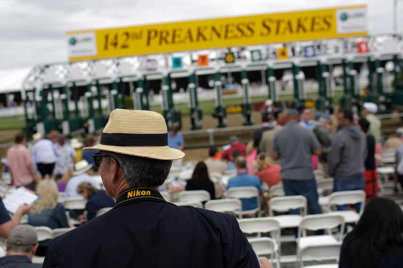 Gleb Taran, of Vienna, Va., watches the action ahead of the running of the 142nd Preakness...