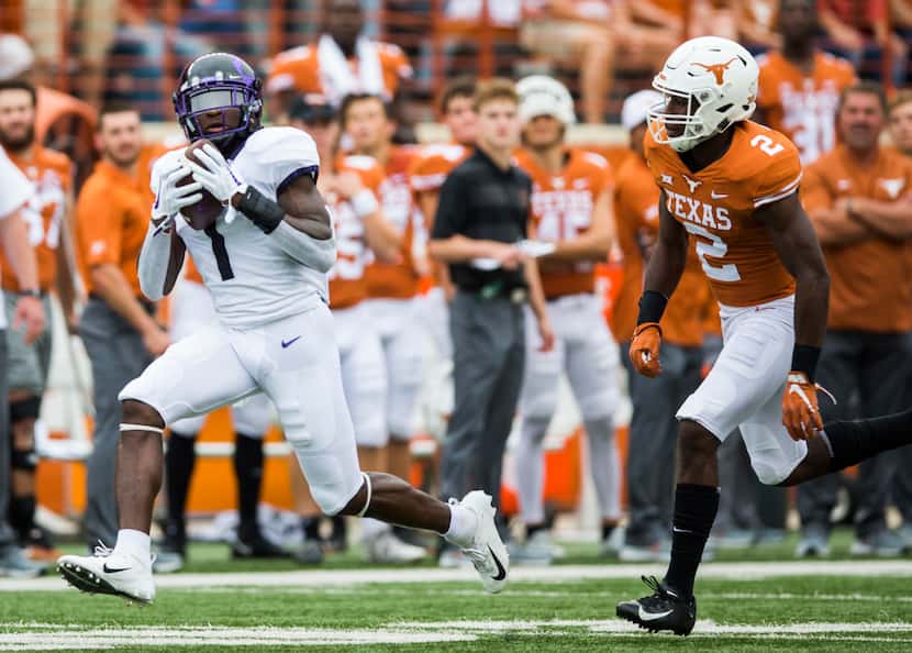 TCU Horned Frogs wide receiver Jalen Reagor (1) catches a pass ahead of Texas Longhorns...
