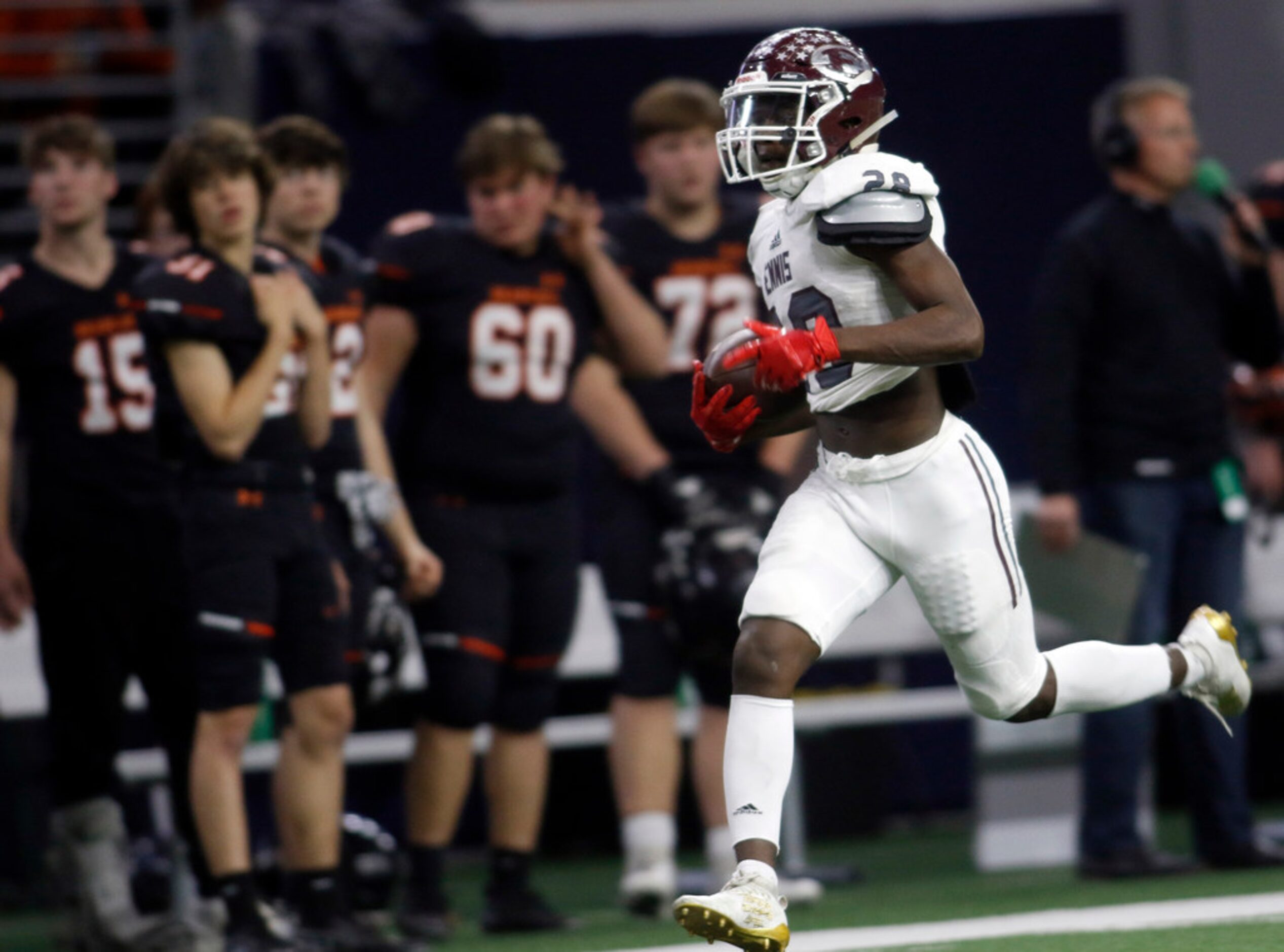 Ennis defensive back Devon Beasley (28) scampers down the sideline past the Aledo bench...