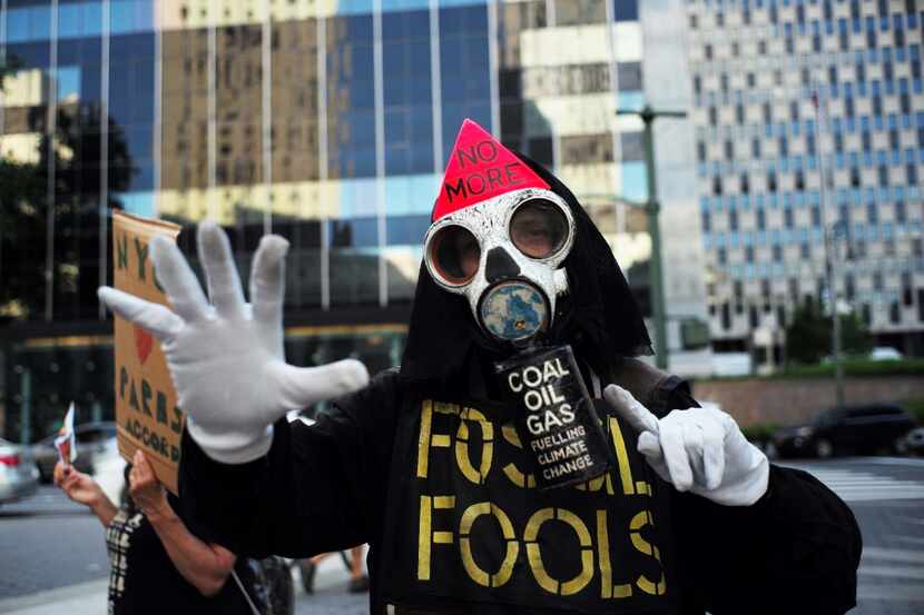 TOPSHOT - Environmental activists and supporters take part in a demonstration in New York on...