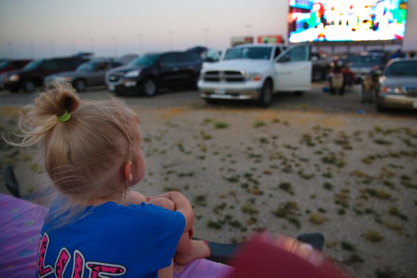 Layla Henderson sits in the bed of her family's truck to watch the Lego Movie at the Texas...