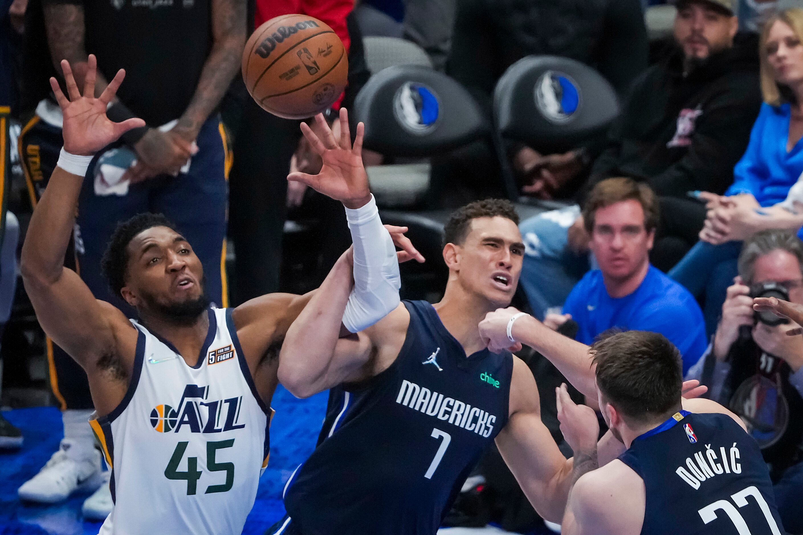 Dallas Mavericks center Dwight Powell (7) gets tangles with Utah Jazz guard Donovan Mitchell...