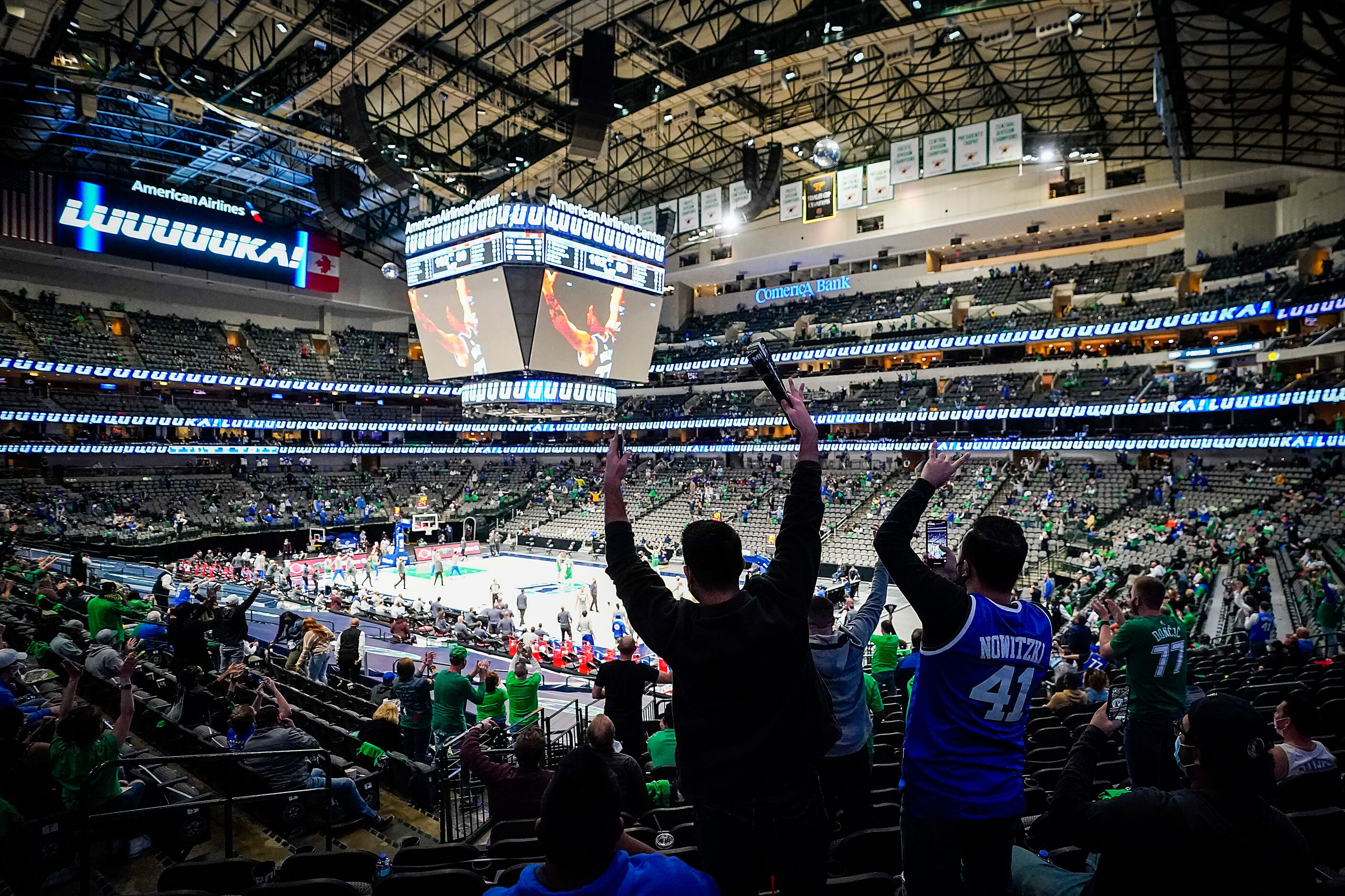 Dallas Mavericks fans celebrate a basket by guard Luka Doncic during the second half of a...