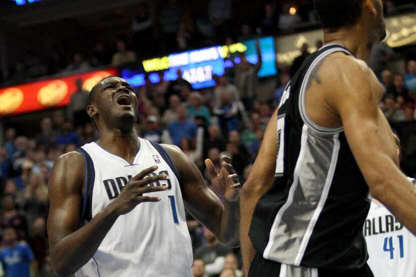 Dallas Mavericks center Samuel Dalembert (1) reacts after the San Antonio Spurs score during...