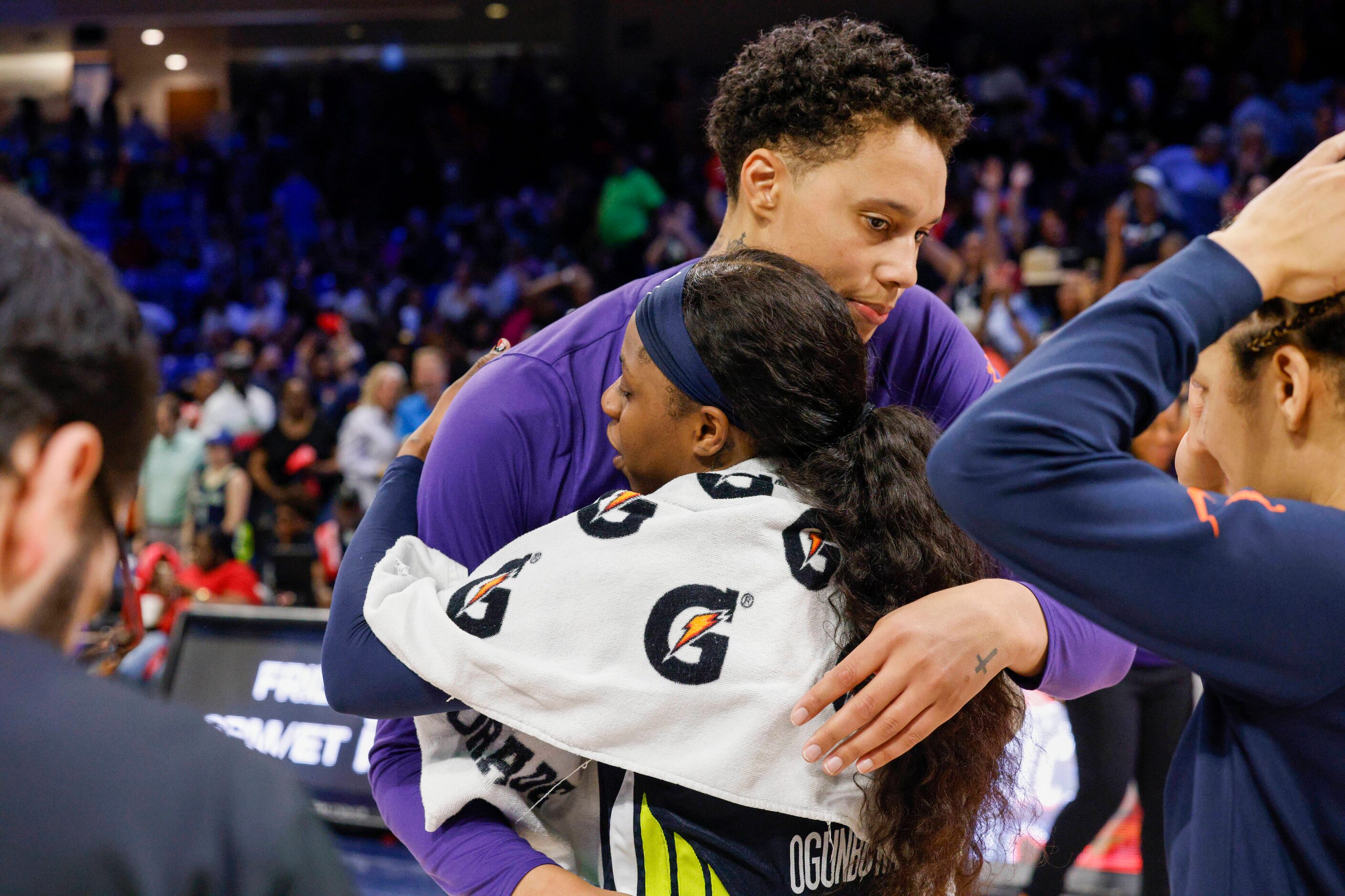 Dallas Wings guard Arike Ogunbowale (24) embraces Phoenix Mercury center Brittney Griner...