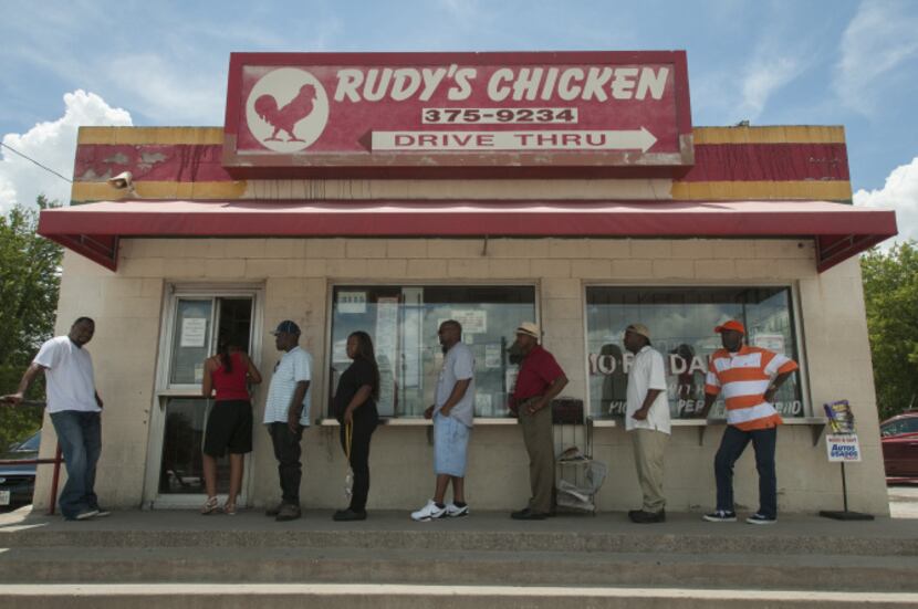 Customers line up to order from Rudy's Chicken on South Lancaster Road.  The city is...