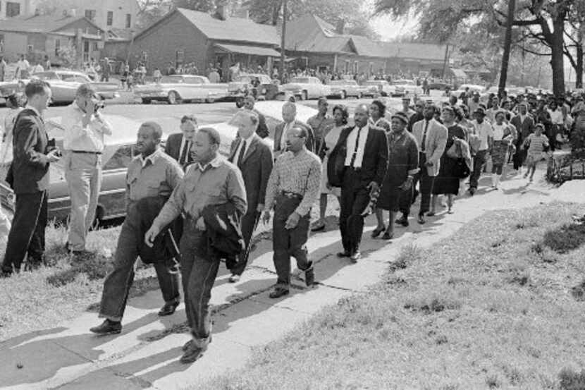 Martin Luther King Jr., front right, and Ralph  Abernathy lead a line of demonstrators who...